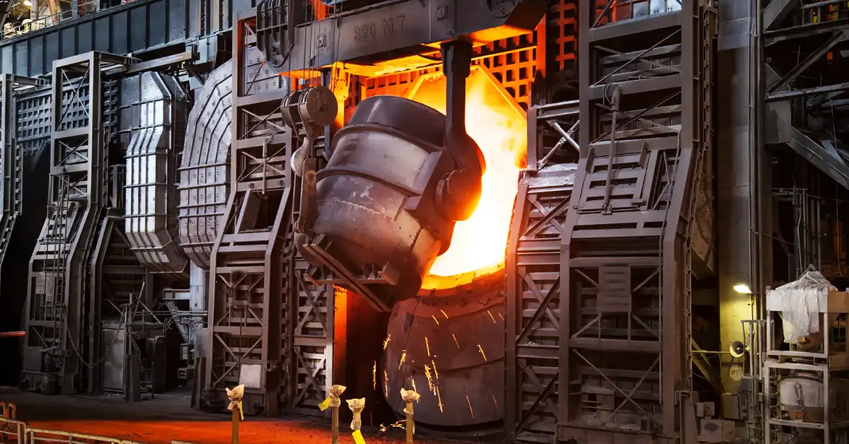 Steel mill with industrial smokestacks emitting smoke